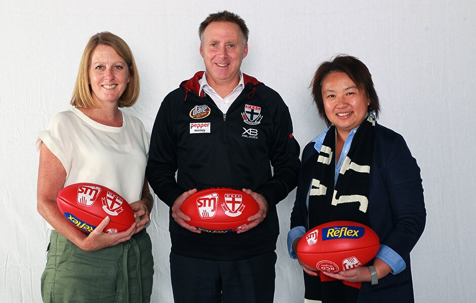 L-R: St Kilda's Lisa Laing (GM Community) and Matt Finnis (CEO) with the SMJFL's Sarah Loh (CEO). - St Kilda Saints